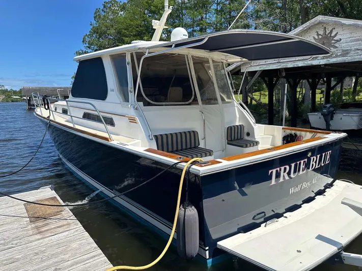 True Blue Yacht Photos Pics 2005 Sabre 42 Express boat docked, named "True Blue," with a sleek design and spacious deck.