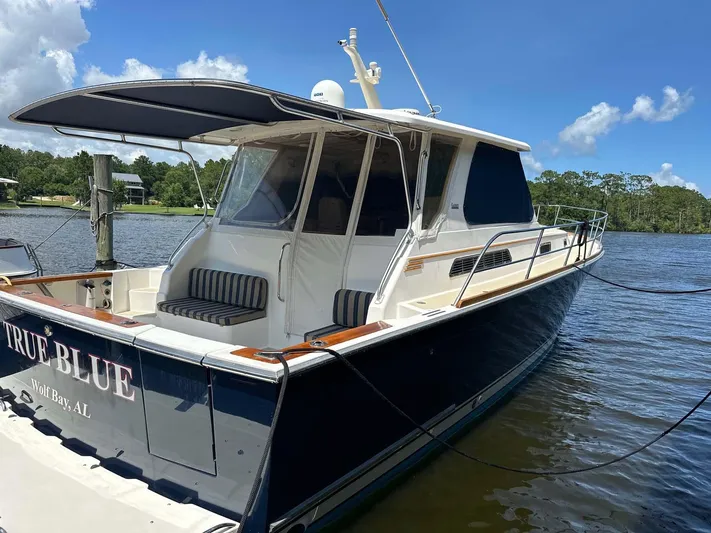 True Blue Yacht Photos Pics 2005 Sabre 42 Express yacht docked on a sunny day, featuring sleek design and spacious deck.