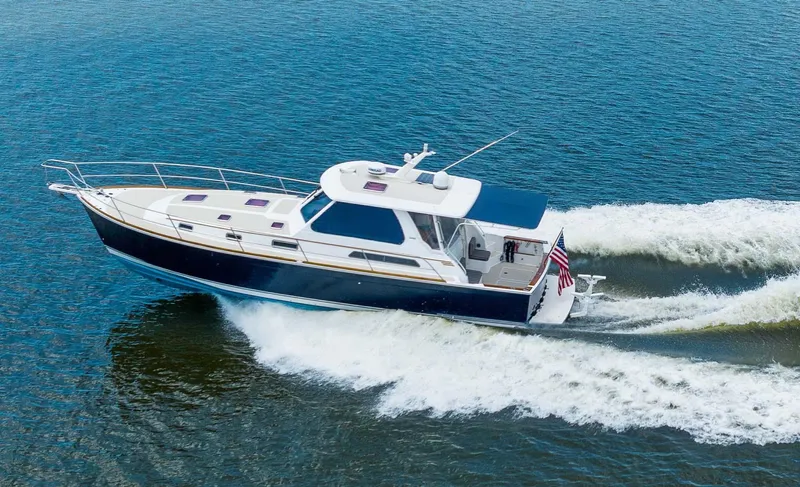 True Blue Yacht Photos Pics 2005 Sabre 42 Express yacht cruising on open water, creating a wake.