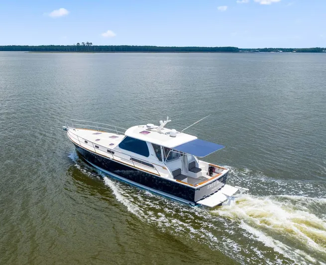 True Blue Yacht Photos Pics 2005 Sabre 42 Express yacht cruising on open water under clear skies.