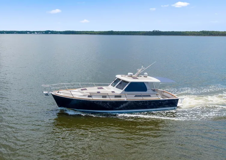 True Blue Yacht Photos Pics 2005 Sabre 42 Express yacht cruising on calm waters under a clear sky.