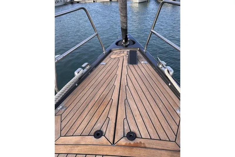 SueÑo Yacht Photos Pics Bow of 2016 Ice Yachts 62 with teak deck, docked in marina.