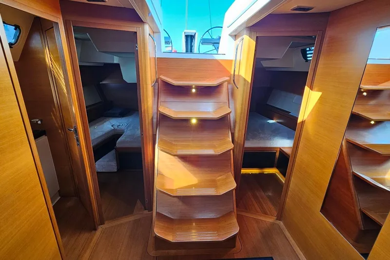 SueÑo Yacht Photos Pics Luxurious interior of 2016 Ice Yachts 62, featuring wooden finishes and cozy cabins.