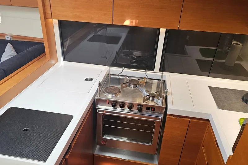 SueÑo Yacht Photos Pics Modern kitchen in 2016 Ice Yachts 62, featuring a sleek stove and wooden cabinetry.