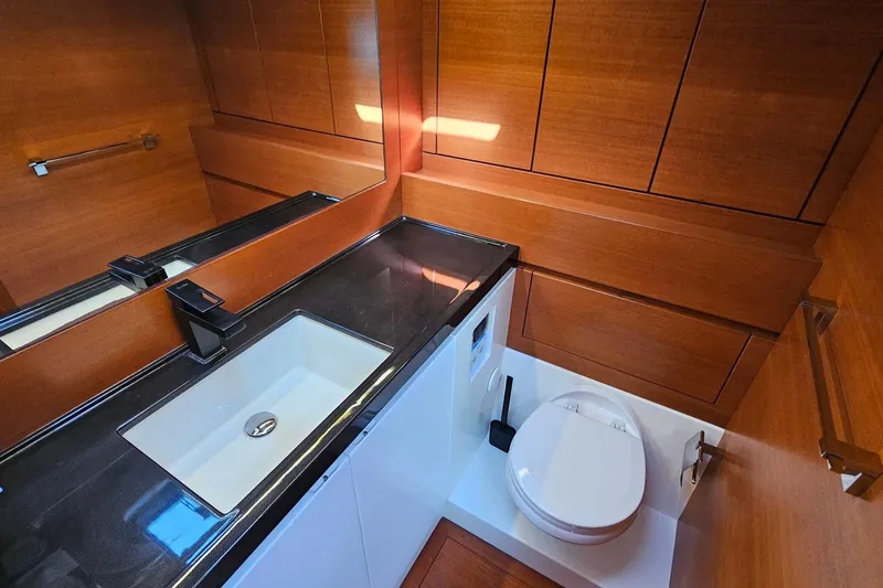 SueÑo Yacht Photos Pics Luxurious bathroom in 2016 Ice Yachts 62, featuring sleek wood paneling and modern fixtures.