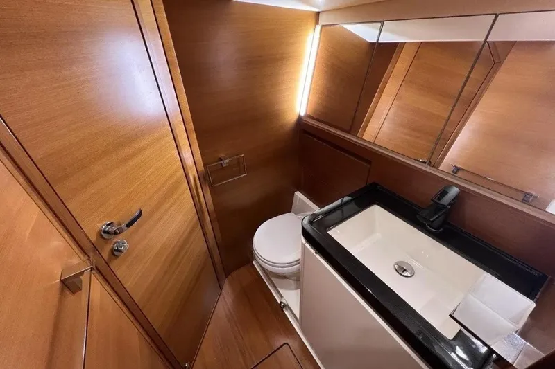 SueÑo Yacht Photos Pics Luxurious 2016 Ice Yachts 62 bathroom with sleek wood finish and modern fixtures.