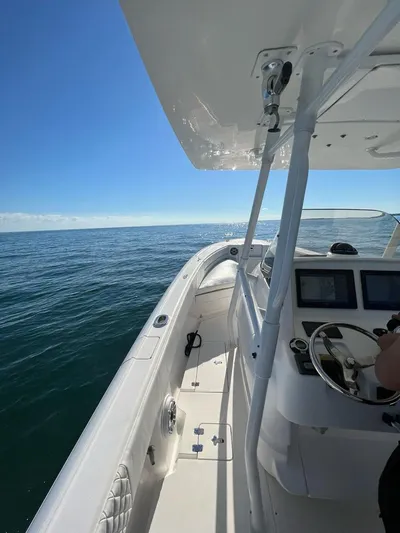  Yacht Photos Pics 2004 Intrepid Outboard boat on open water, clear blue sky, and calm sea.