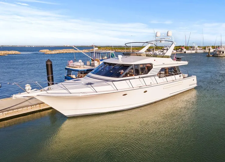 Five O'clock Yacht Photos Pics Luxury 2000 West Bay 58 Sonship yacht docked in a serene marina setting.