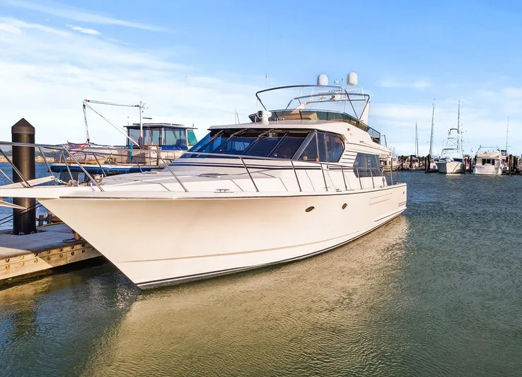 Five O'clock Yacht Photos Pics Luxury 2000 West Bay 58 Sonship yacht docked in marina under clear blue sky.