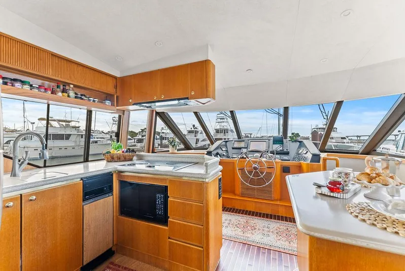 Five O'clock Yacht Photos Pics Luxurious interior of 2000 West Bay 58 Sonship yacht with modern kitchen and helm.