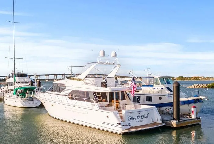 Five O'clock Yacht Photos Pics 2000 West Bay 58 Sonship yacht docked at marina under clear blue sky.
