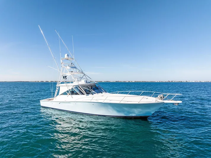 Hog Wild Yacht Photos Pics 2007 Viking 52 Open yacht on calm blue sea under clear sky.