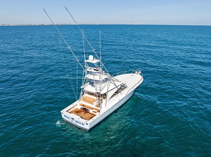 Hog Wild Yacht Photos Pics 2007 Viking 52 Open yacht on open sea, clear blue water, sunny day.