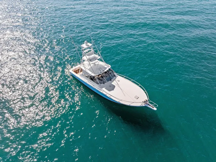 Hog Wild Yacht Photos Pics 2007 Viking 52 Open yacht cruising on clear blue water.