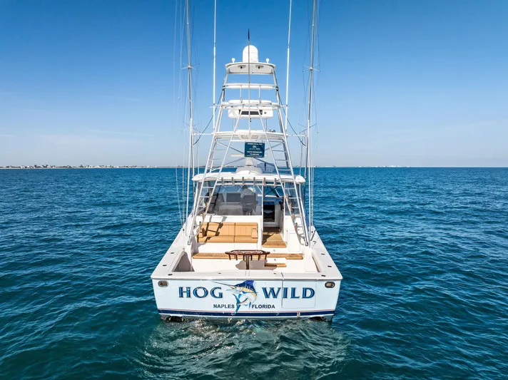 Hog Wild Yacht Photos Pics 2007 Viking 52 Open yacht on open sea, rear view, "Hog Wild" name visible.