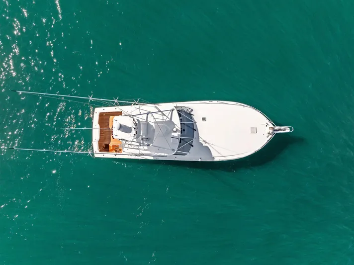 Hog Wild Yacht Photos Pics Aerial view of 2007 Viking 52 Open yacht on turquoise water.