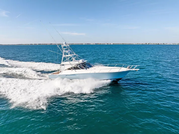 Hog Wild Yacht Photos Pics 2007 Viking 52 Open yacht cruising on clear blue ocean waters.