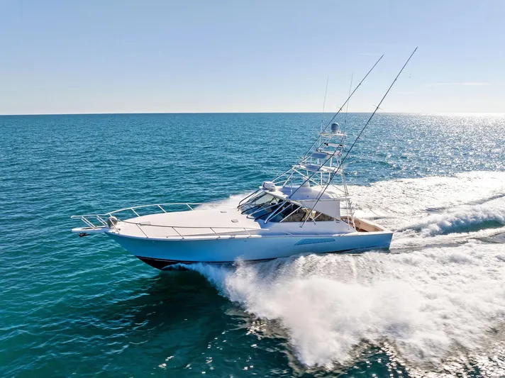 Hog Wild Yacht Photos Pics 2007 Viking 52 Open yacht cruising on open sea under clear blue sky.