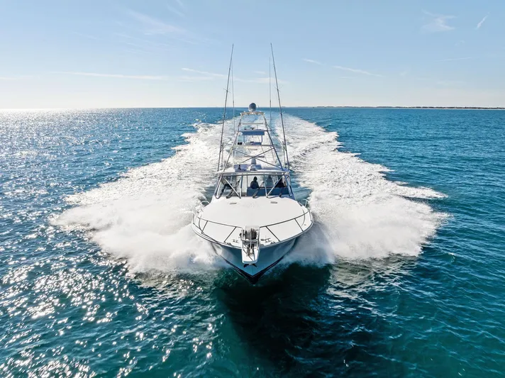 Hog Wild Yacht Photos Pics 2007 Viking 52 Open yacht cruising on clear blue ocean waters.