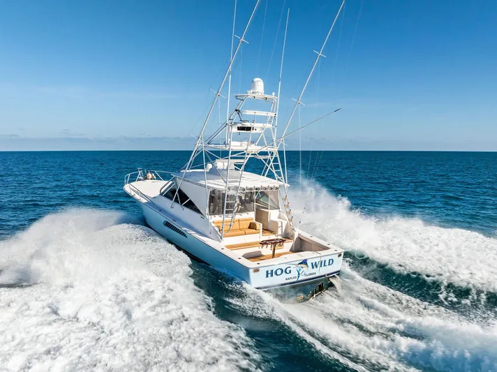 Hog Wild Yacht Photos Pics 2007 Viking 52 Open yacht cruising on open sea, creating waves.