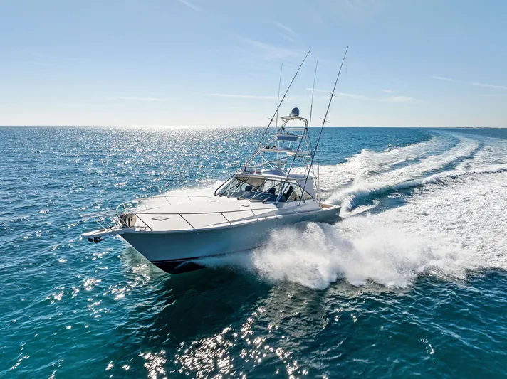 Hog Wild Yacht Photos Pics 2007 Viking 52 Open yacht cruising on open sea, creating a dynamic water trail.