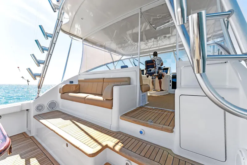 Hog Wild Yacht Photos Pics 2007 Viking 52 Open yacht interior with seating and helm, featuring teak flooring.