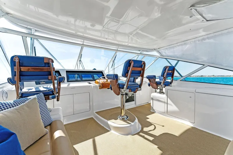 Hog Wild Yacht Photos Pics Interior of 2007 Viking 52 Open yacht with helm chairs and panoramic windows.