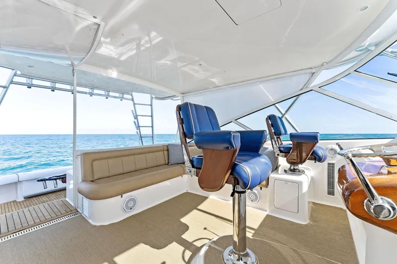Hog Wild Yacht Photos Pics 2007 Viking 52 Open yacht interior with blue captain chairs and ocean view.