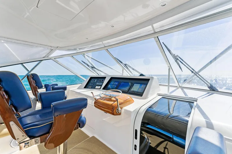 Hog Wild Yacht Photos Pics Interior of 2007 Viking 52 Open yacht with blue seating and navigation controls.