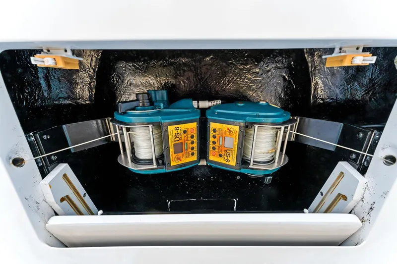 Hog Wild Yacht Photos Pics Fishing equipment on a 2007 Viking 52 Open boat, featuring dual reels in a storage compartment.