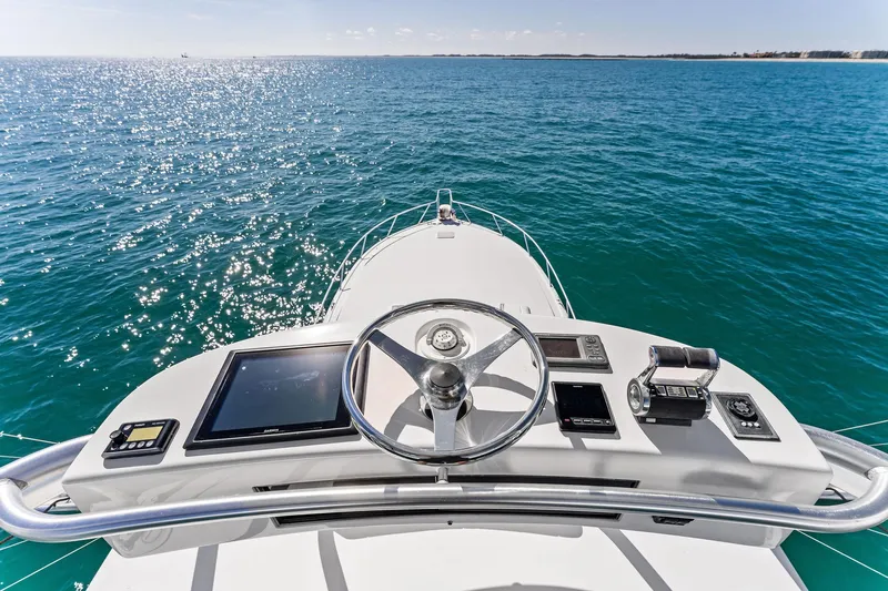 Hog Wild Yacht Photos Pics 2007 Viking 52 Open yacht helm with ocean view, featuring modern navigation equipment.