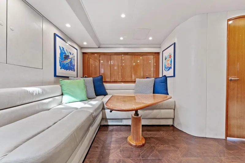 Hog Wild Yacht Photos Pics Interior of 2007 Viking 52 Open yacht with plush seating and wooden table.