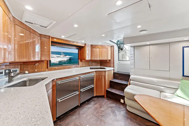 Hog Wild Yacht Photos Pics Luxurious interior of a 2007 Viking 52 Open yacht with modern kitchen and seating area.