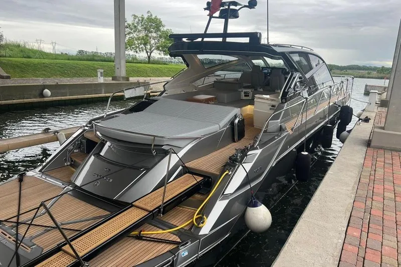 Cranchi St 60 2023 Yacht Photos Pics 2023 Cranchi 60 ST yacht docked, showcasing sleek design and luxurious deck features.