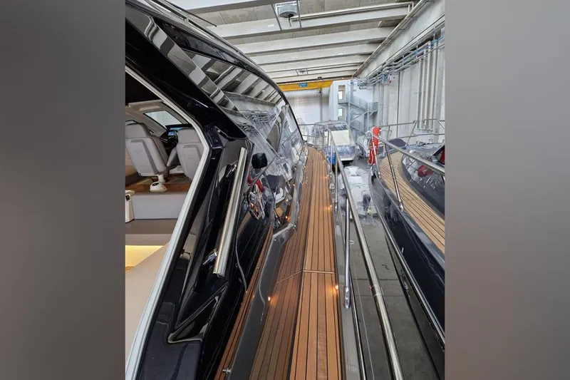 Cranchi St 60 2023 Yacht Photos Pics 2023 Cranchi 60 ST yacht interior with sleek design and wooden deck in a showroom.