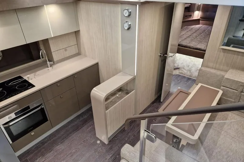 Cranchi St 60 2023 Yacht Photos Pics Modern interior of 2023 Cranchi 60 ST yacht with sleek kitchen and cozy seating area.