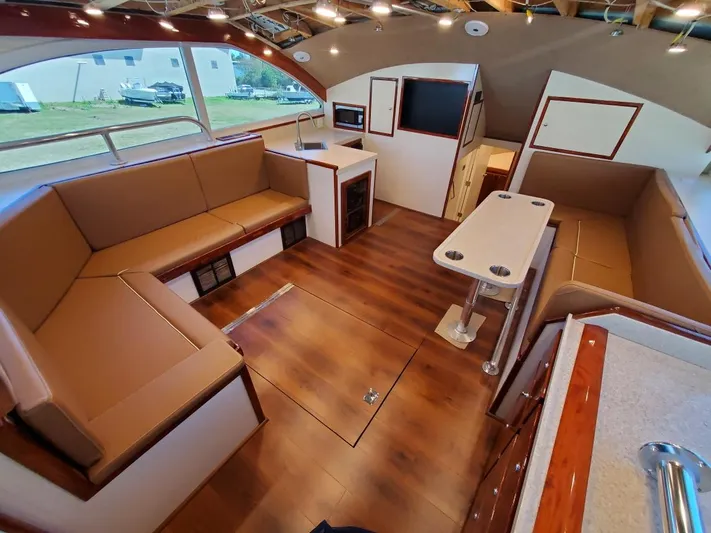  Yacht Photos Pics Luxurious interior of 2005 Custom Carolina C 30 CAT yacht with modern seating and wood flooring.