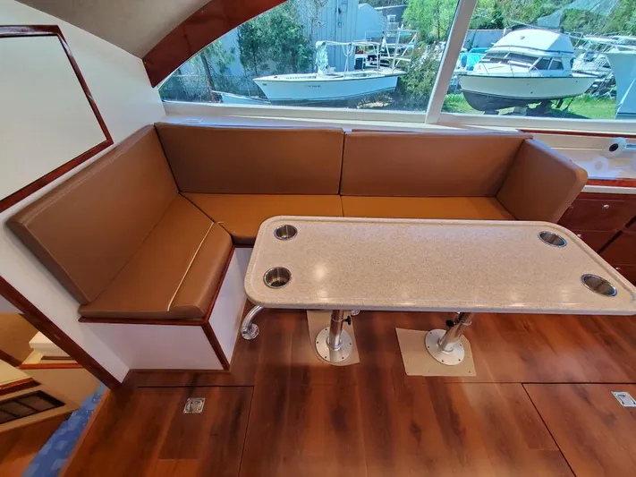 Yacht Photos Pics Luxurious 2005 Custom Carolina C 30 CAT yacht interior with brown seating and table.
