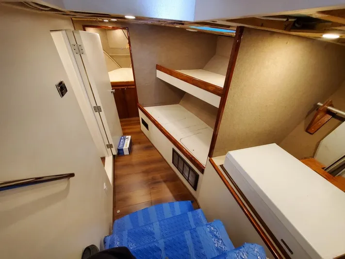  Yacht Photos Pics Interior of 2005 Custom Carolina C 30 CAT boat with wooden flooring and bunk beds.