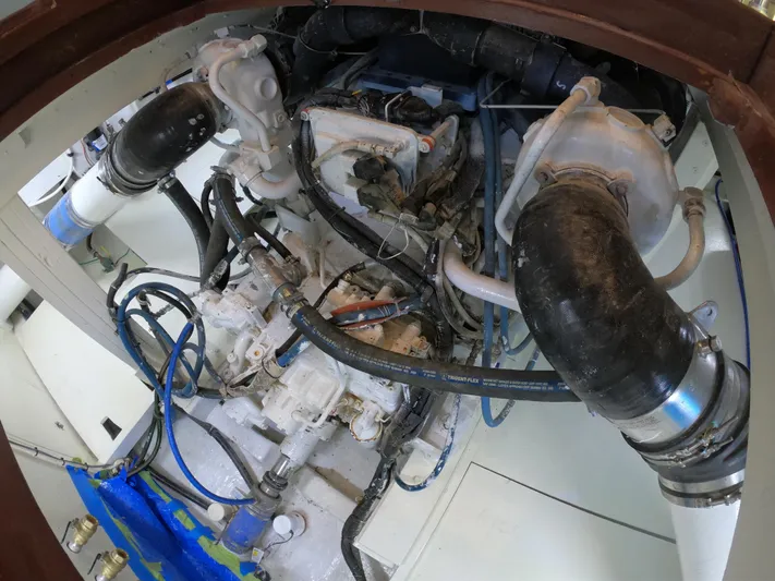  Yacht Photos Pics Engine compartment of 2005 Custom Carolina C 30 CAT boat, showcasing mechanical components and hoses.
