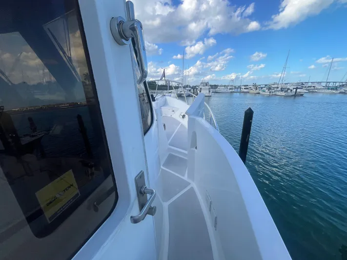 September Song Yacht Photos Pics 2007 DeFever 55 yacht docked in marina with blue sky.