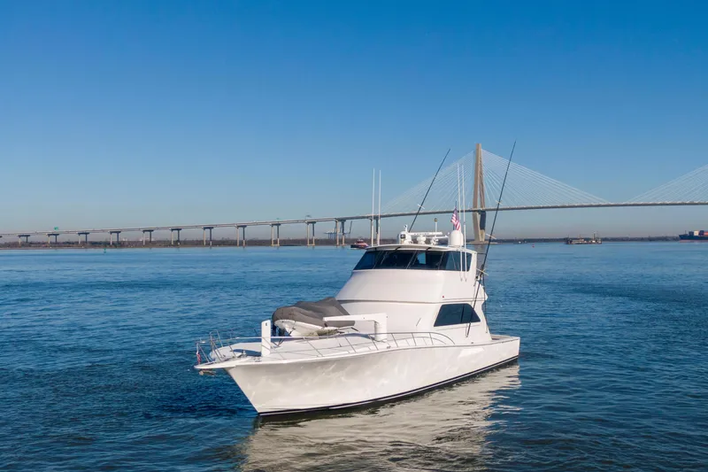 Prime Time Yacht Photos Pics 2002 Viking 65 Enclosed Bridge yacht cruising near a large suspension bridge.