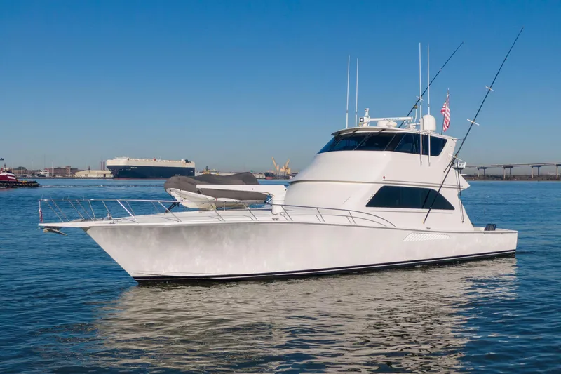 Prime Time Yacht Photos Pics 2002 Viking 65 Enclosed Bridge yacht on calm water, clear sky background.
