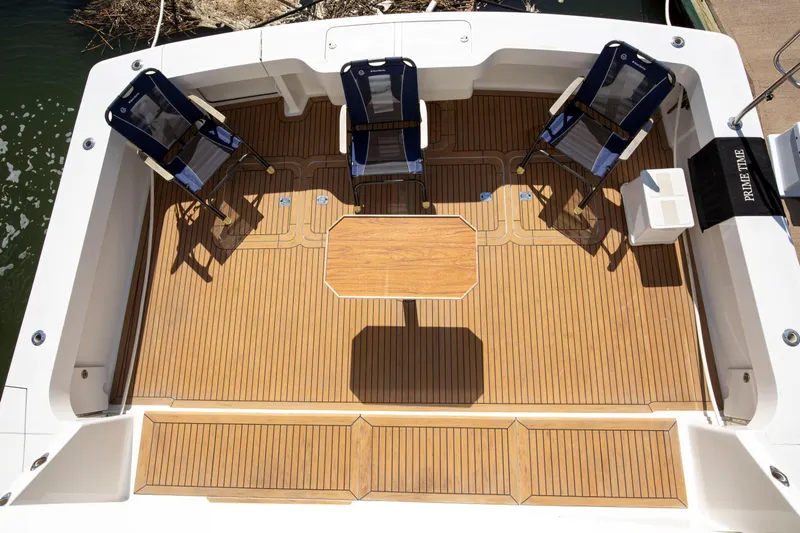 Prime Time Yacht Photos Pics 2002 Viking 65 Enclosed Bridge yacht deck with chairs and table.