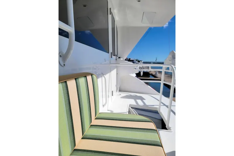 Prime Time Yacht Photos Pics Striped seating on 2002 Viking 65 Enclosed Bridge yacht deck, with ocean view.