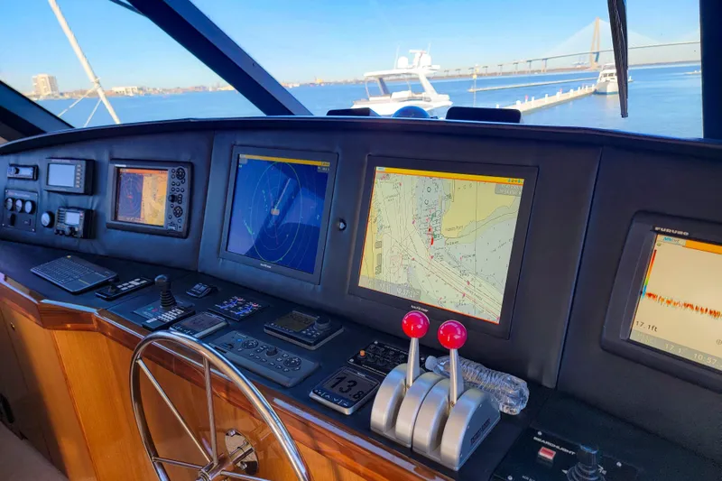 Prime Time Yacht Photos Pics Bridge of 2002 Viking 65 Enclosed Bridge yacht with navigation screens and controls.