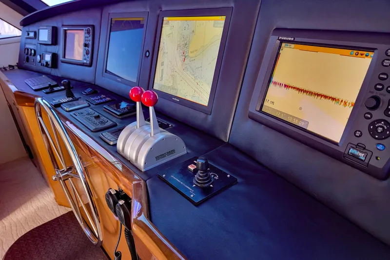 Prime Time Yacht Photos Pics Control panel of a 2002 Viking 65 Enclosed Bridge yacht with navigation screens.