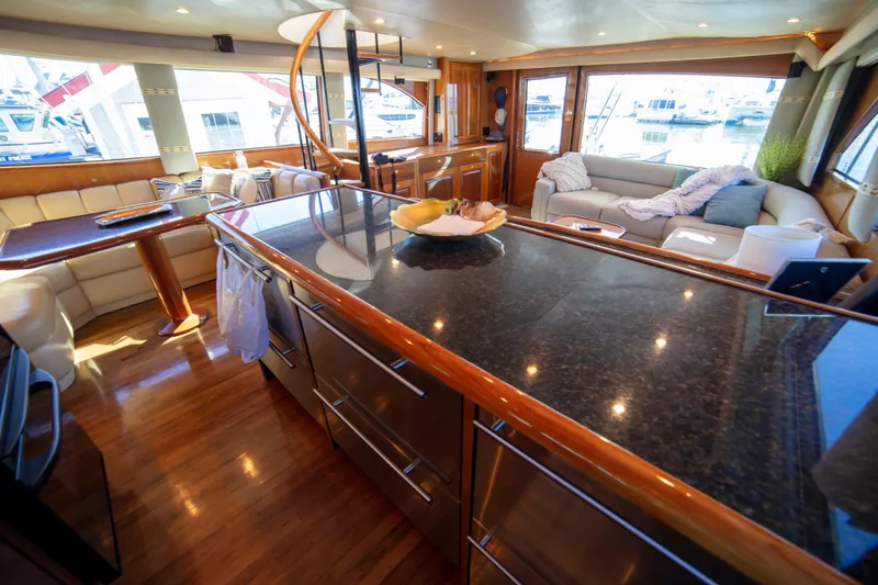 Prime Time Yacht Photos Pics Luxurious interior of 2002 Viking 65 Enclosed Bridge yacht with modern furnishings.