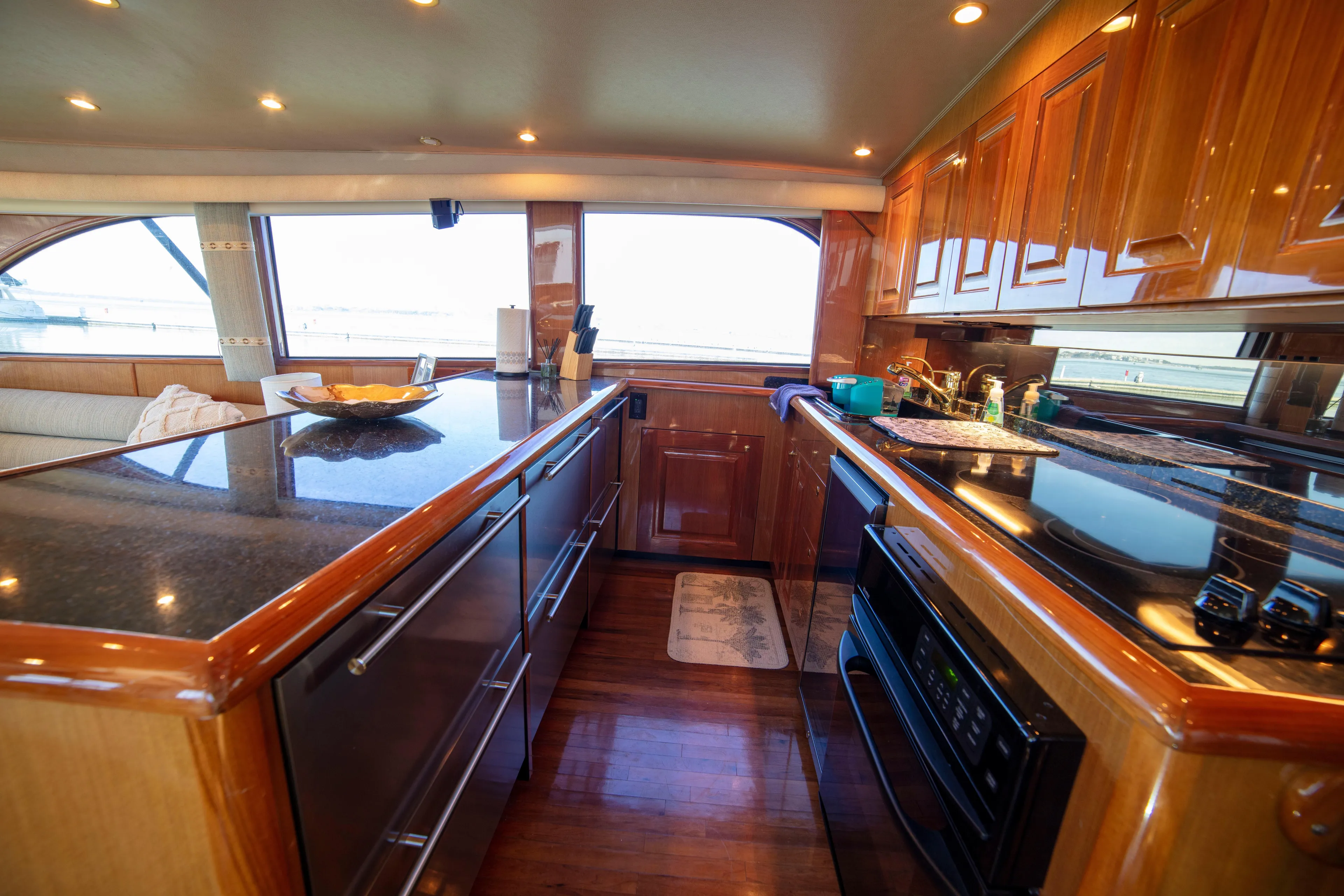 Prime Time Yacht Photos Pics Luxurious kitchen interior of 2002 Viking 65 Enclosed Bridge yacht with wood cabinetry and modern appliances.