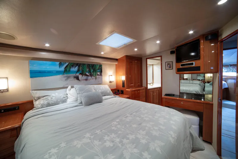 Prime Time Yacht Photos Pics Luxurious bedroom interior of 2002 Viking 65 Enclosed Bridge yacht with beach-themed decor.